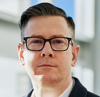 Porträt von Alexander Hughes, CEO und Führungskraft eines Krypto-Trading-Unternehmens